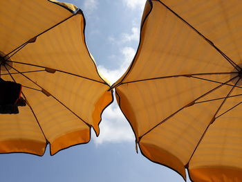 Low angle view of parasol against sky