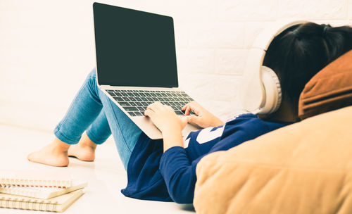 Girl using laptop on floor at home