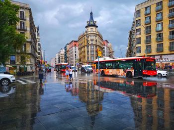 Reflection of buildings on wet street in rainy season
