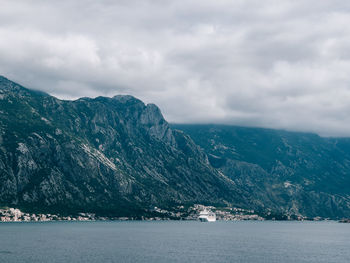 Scenic view of sea and mountains against sky