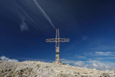 Low angle view of cross against blue sky