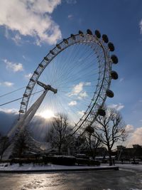 Low angle view of ferris wheel against sky