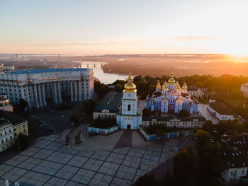 High angle view of buildings in town at sunset