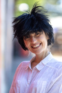 Young woman with scruffy hairstyle smiling