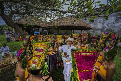 Balinese holly men giving bless for rejang dancing ritual