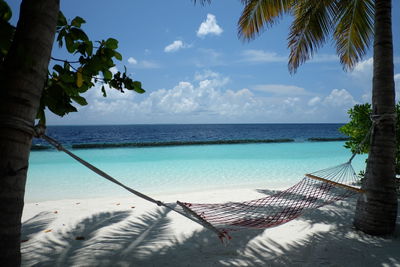 Scenic view of swimming pool by sea against sky