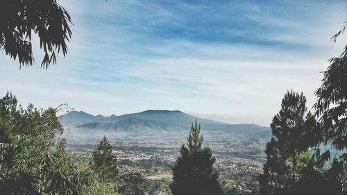 Scenic view of mountains against cloudy sky