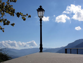 Lighting equipment on retaining wall against sky