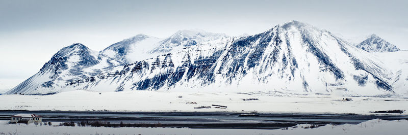 Scenic view of snow covered mountains against sky