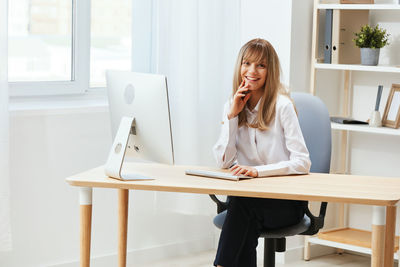 Young woman using laptop at office