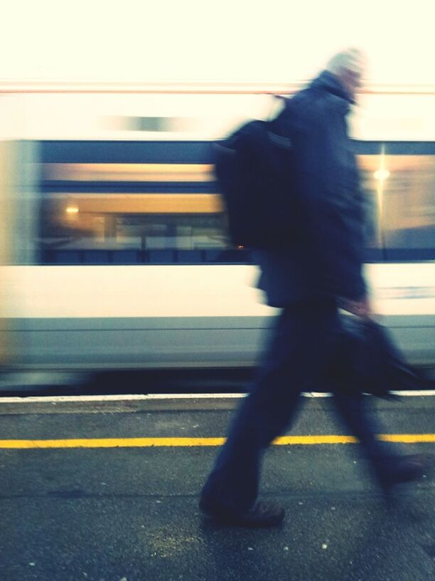 transportation, mode of transport, blurred motion, on the move, public transportation, motion, railroad station platform, railroad station, land vehicle, travel, road, speed, street, men, railroad track, car, road marking, train - vehicle