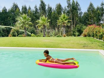 Girl on air mattress in swimmingpool