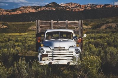 Abandoned car on field