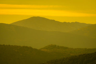 Scenic view of mountains against sky during sunset