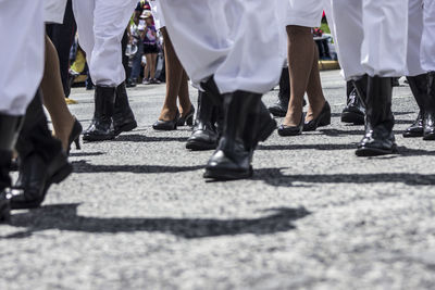 Low section of people walking on street