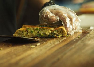 Close-up of hand serving pie