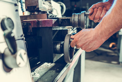 Cropped hand of man repairing car