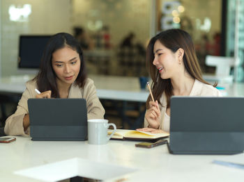 Young businesswomen brainstorming at office