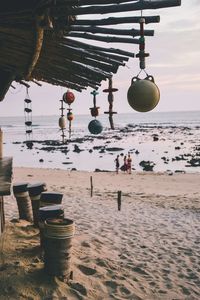 Clothes hanging on beach against sky