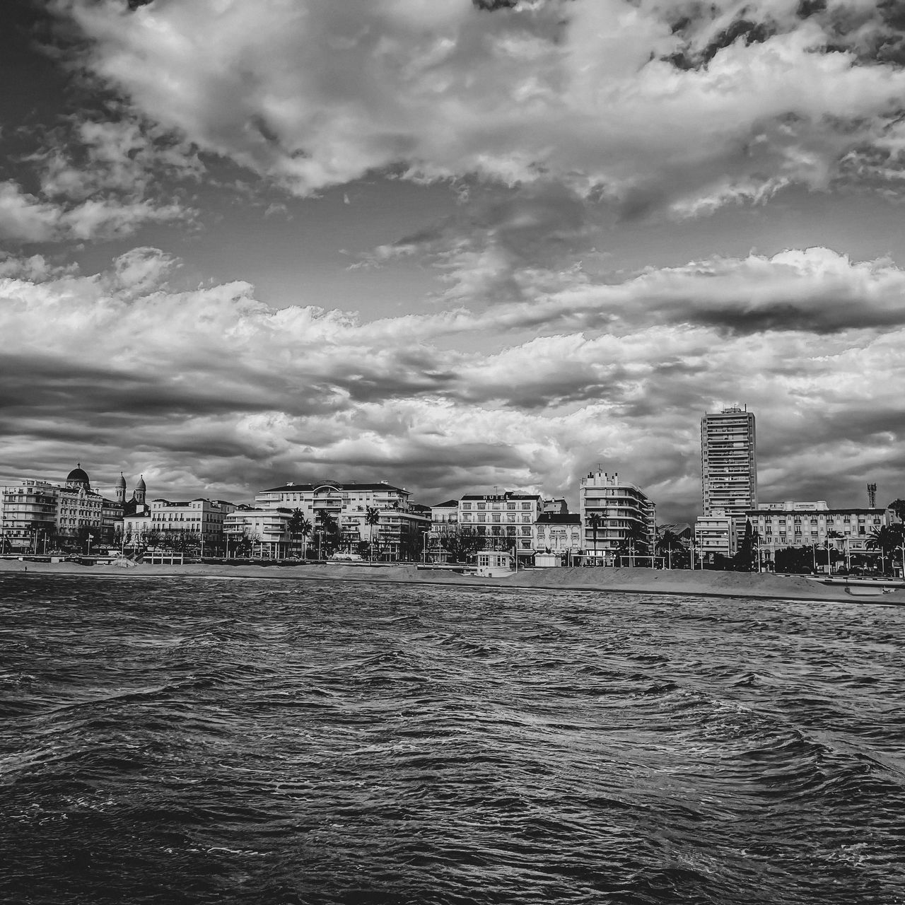 SEA AND BUILDINGS AGAINST SKY