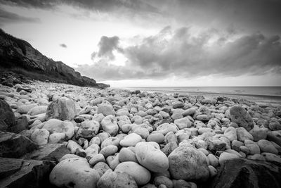 Rocks on beach against sky