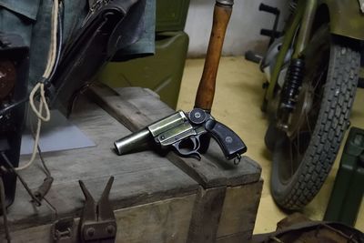 High angle view of pistol on table in garage