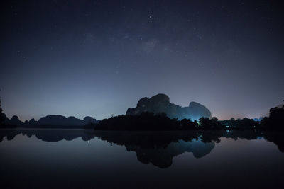 Scenic view of lake against sky at night