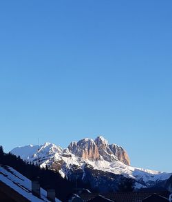 Scenic view of snowcapped mountains against clear blue sky