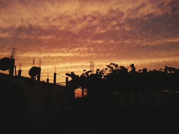 Silhouette buildings against sky during sunset