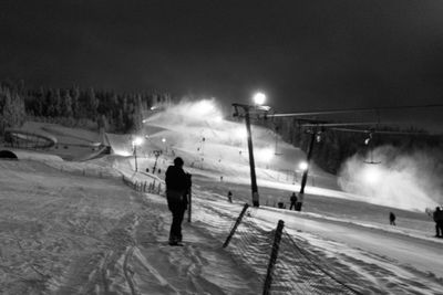 Man on snow covered landscape at night