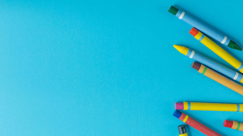 Close-up of colored pencils against blue background