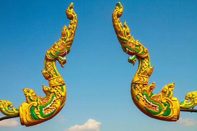 Low angle view of statue against blue sky