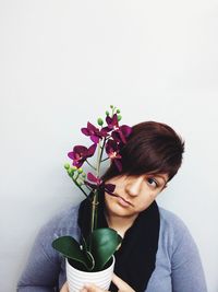 Close-up of woman holding white flower