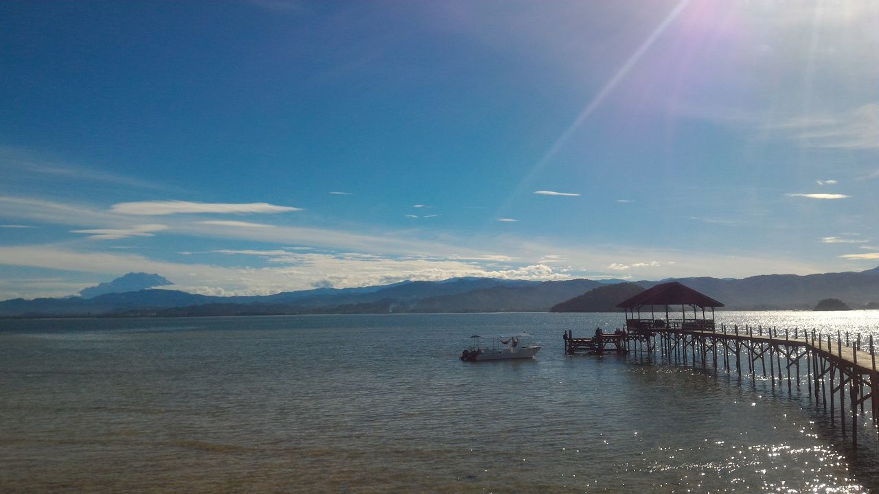 sky, nature, water, blue, tranquil scene, beauty in nature, scenics, mountain, tranquility, cloud - sky, architecture, outdoors, sea, no people, day