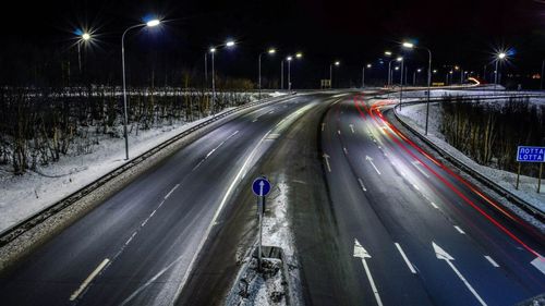 Light trails on road in city at night