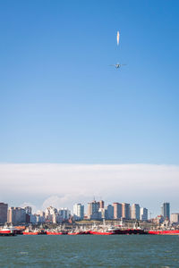 View of sea and buildings against sky