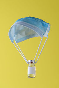 Close-up of light bulb against yellow background