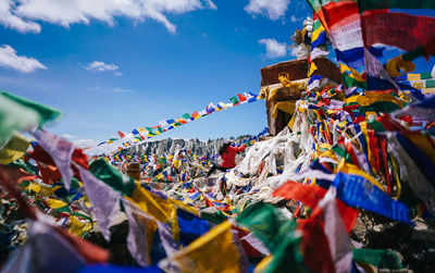 Low angle view of flags hanging against sky