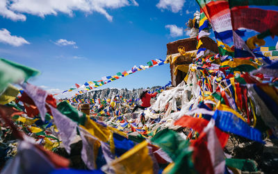 Multi colored praying flags hanging against sky