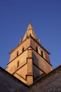 Low angle view of building against clear blue sky