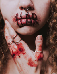 Midsection of woman with blood on hand