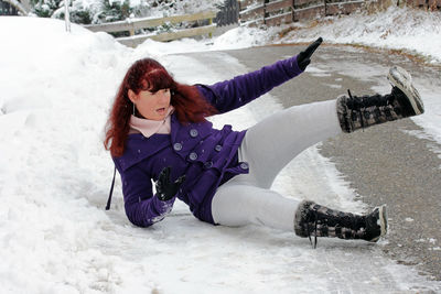 Woman lying down on snow field