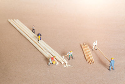 Miniature people carpenter making bamboo toothpick from bamboo, recycle concept