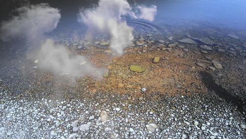 High angle view of water splashing on rocks