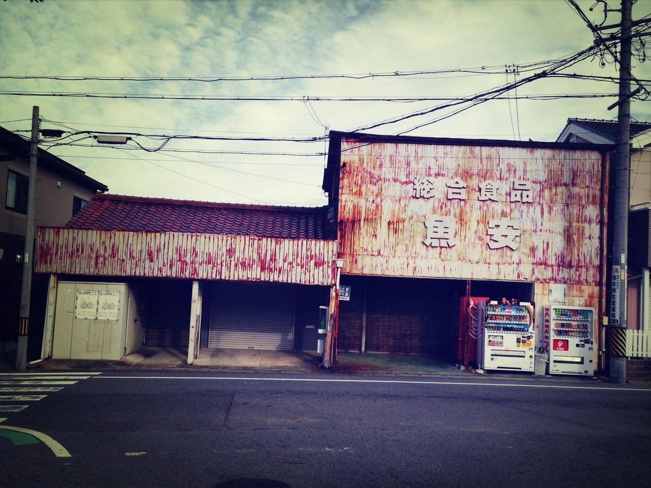 building exterior, architecture, built structure, street, transportation, road, sky, power line, text, house, graffiti, communication, outdoors, cable, day, western script, no people, the way forward, residential building, residential structure