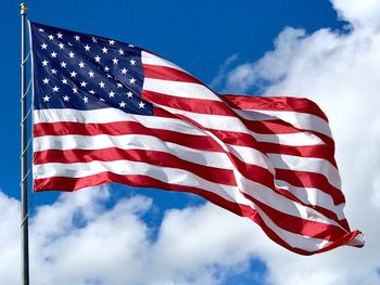 Low angle view of flag against sky