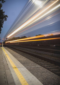 Train at railroad station against sky at night