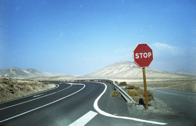 Road sign against clear sky