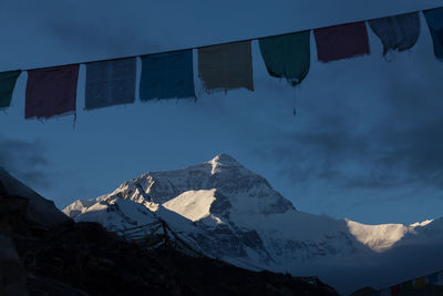 Low angle view of flags against mountain range