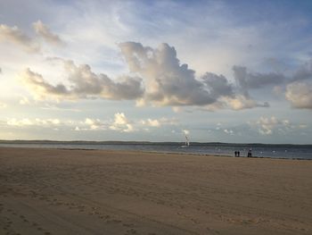 View of beach against cloudy sky